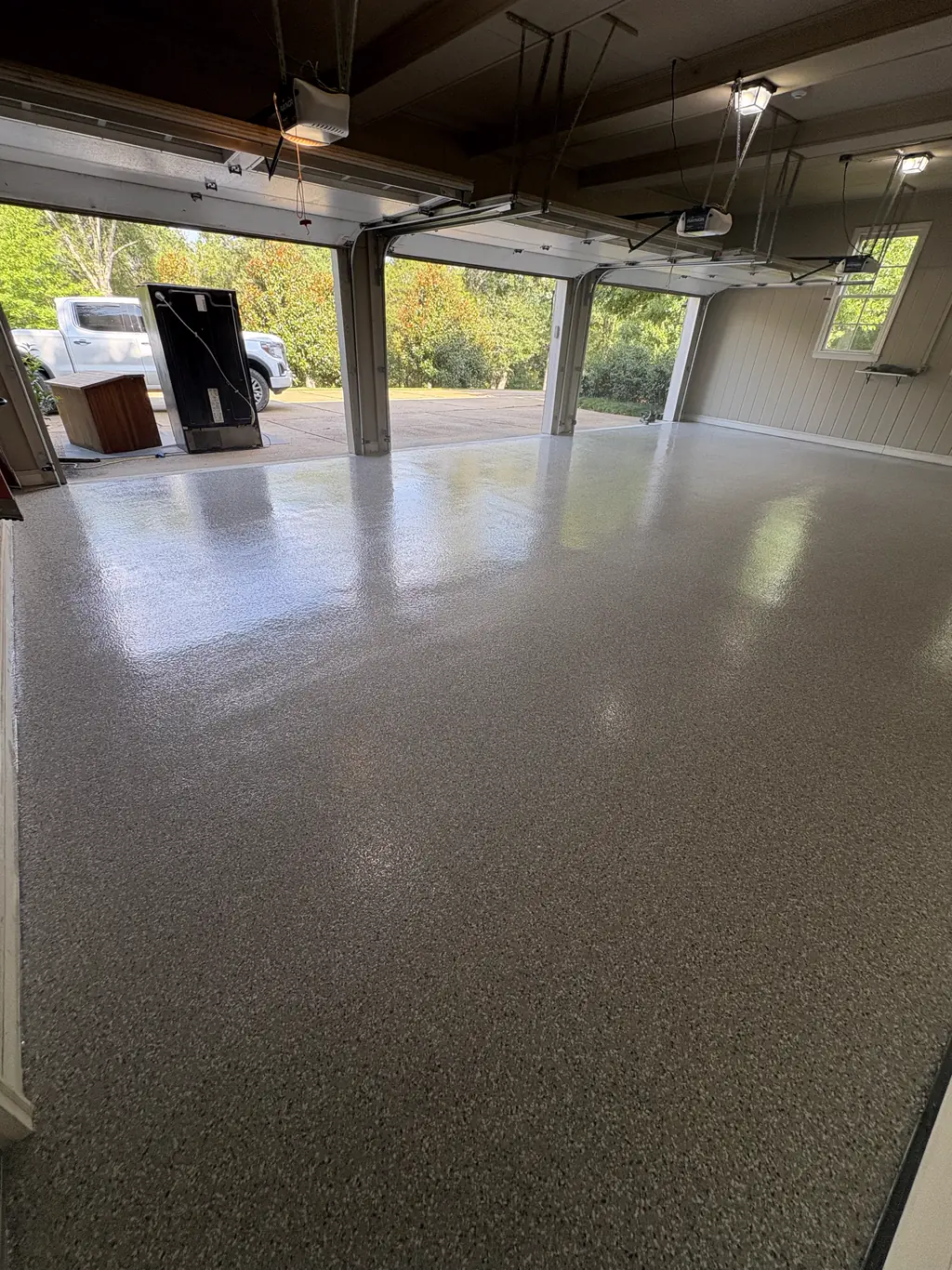 Garage floor finished in charcoal flake epoxy with a wet look gloss