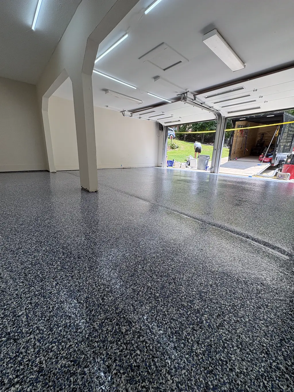 Residential garage in Mississippi finished with a gray and black vinyl flake epoxy floor