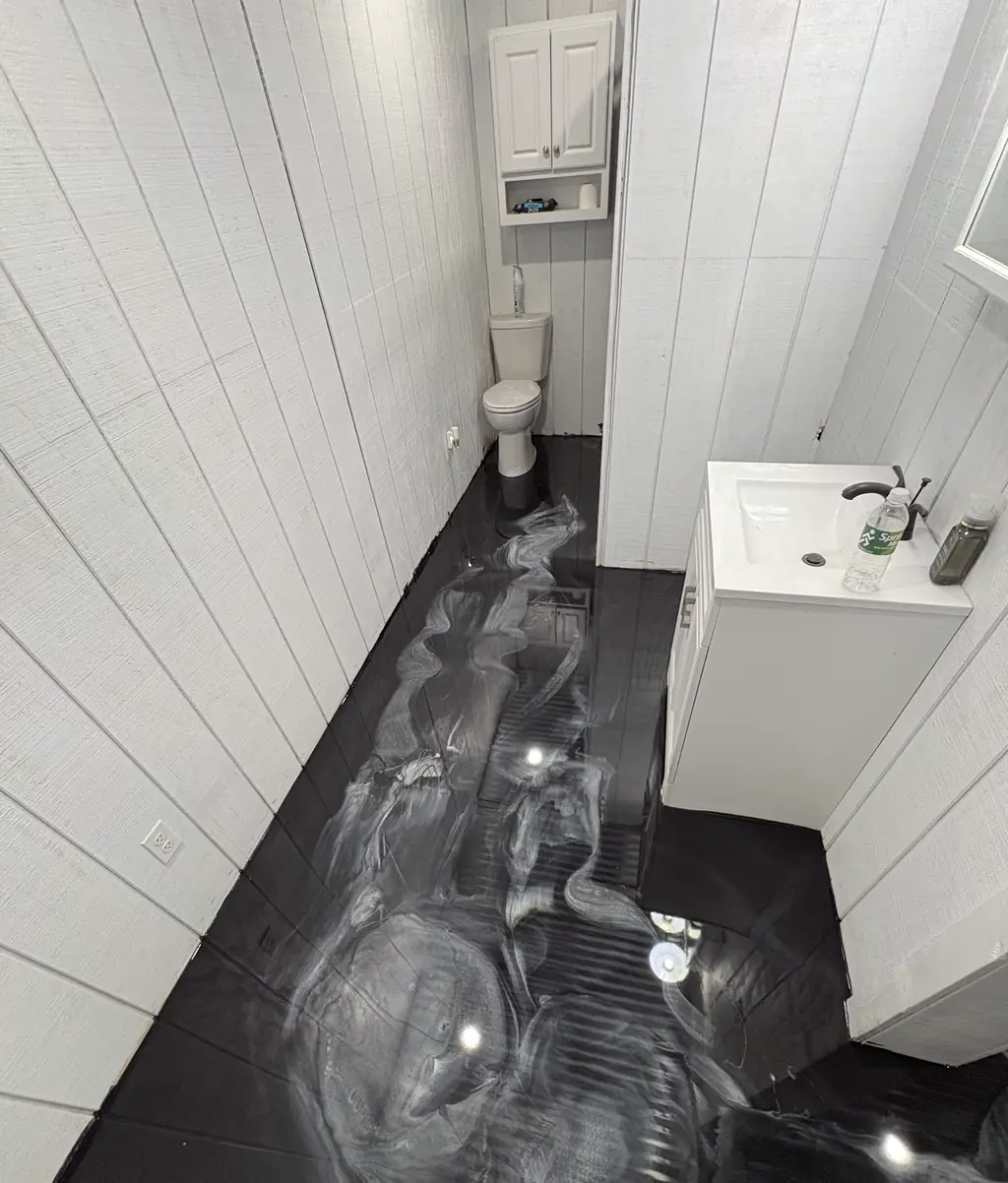Small bathroom with a dark metallic epoxy floor and white shiplap walls